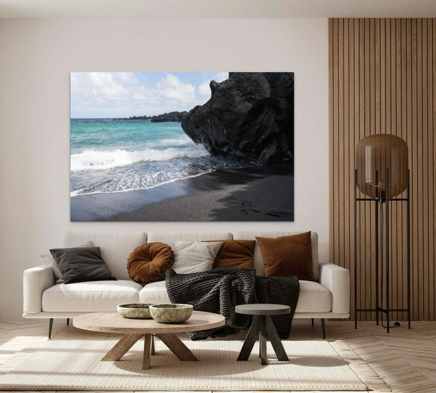 Black sand beach and volcanic rock, Maui, Hawaii metal print, shown in a room